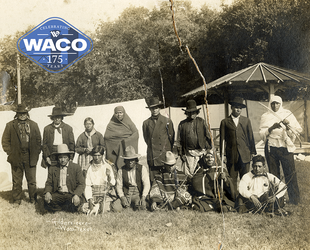 Sepia photo of Native American dressed in modest clothing