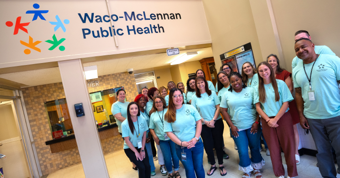 Group of people posing with the new Waco-McLennan Public Health Logo