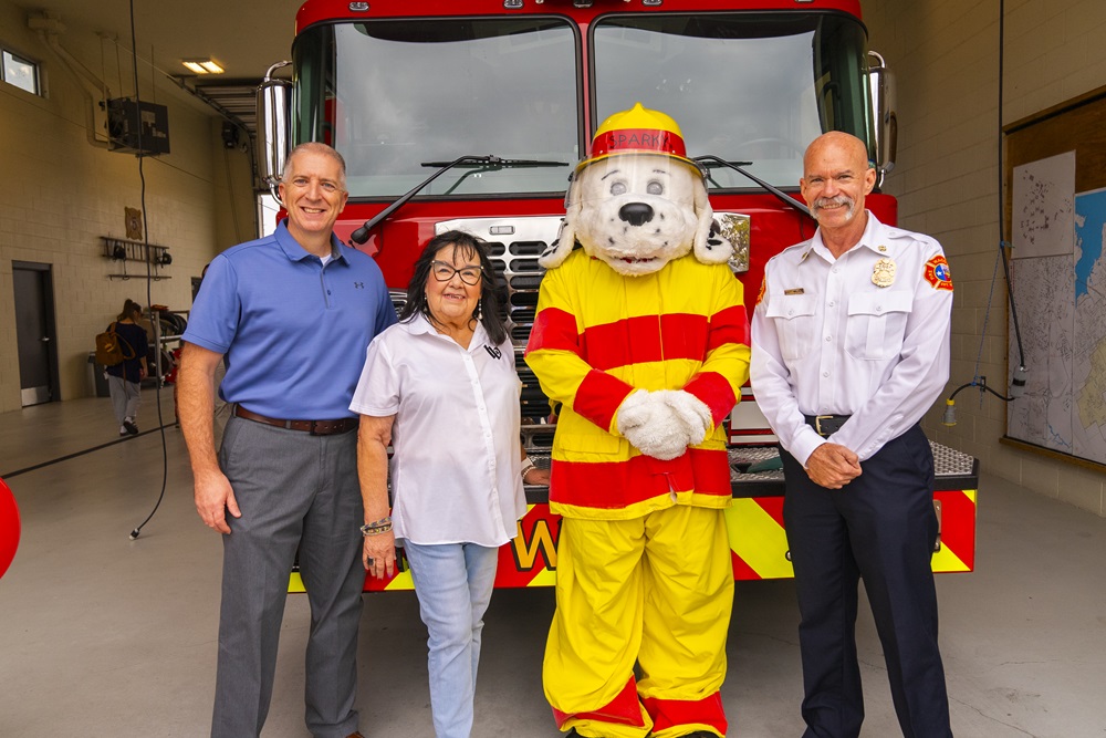 Waco firefighters with city councilwoman and Sparky the Fire Dog in front of a fire engine