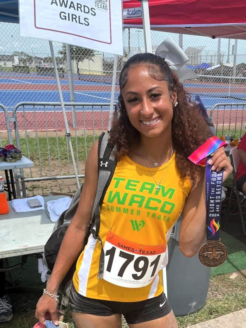 Team Waco athlete holding medal