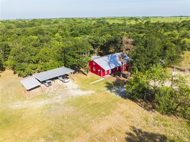 Aerial view of the back exterior with the carport