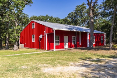 Front exterior of the red house on the Axtell property.