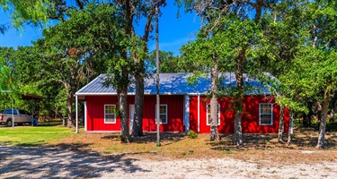 Exterior of the red house on the Axtell property.